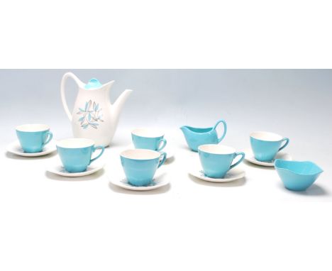 A mid century Midwinter Modern Fashion Shape blue and white coffee set having floral decoration to the coffee pot and saucers