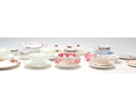 A collection of part china tea sets and cup and sauces to include Royal Albert Country Roses, Paragon tea cabinet cup and sau