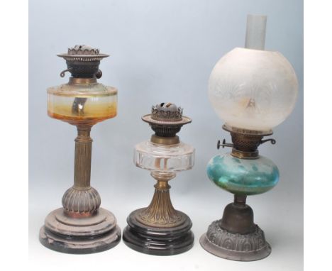 A group of three 19th century Victorian oil lamps to include one having a ceramic base with brass colour and clear faceted gl