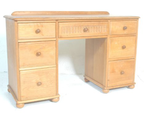 A good 20th Century light oak kneehole&nbsp; twin pedestal desk,having carved central kneehole drawer with each pedestal havi