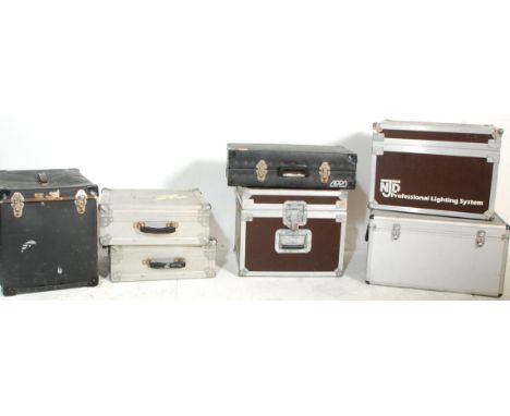 A group of seven music equipment carry case with most being flight cases and some bearing makers plaques to include NJD Profe