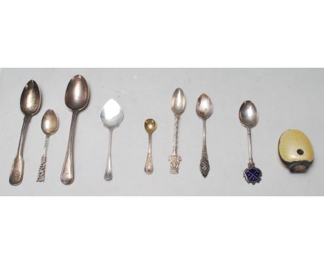 A good mixed group of silver spoons dating from the early 20th Century to include a golfing example with enameled end bearing