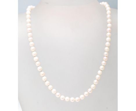 A hallmarked 9ct gold ladies cultured pearl necklace having a strand of spherical pearls set with a gold clasp. Weighs 22g. M