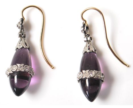 A pair of early 20th Century Edwardian amethyst and diamond drop earrings having polished amethyst drops set with diamond acc