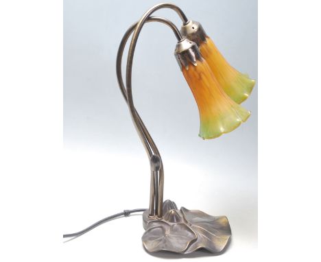 A 20th Century Tiffany style desk / table lamp having two yellow and green mottled glass shades modelled as flowers, on a bas