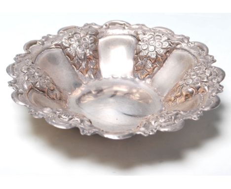 A 20th Century Egyptian silver small bowl / trinket dish having alternate panelled decoration with repousse floral decoration