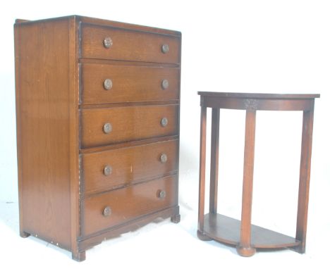 A 1930s art deco vintage oak panel chest of drawers having a gallery back over five graduating drawers with floral shaped pul