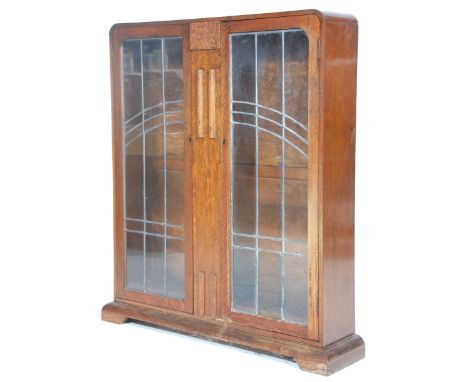 An 1930's Art Deco Oak China Display Cabinet vitrine with twin leaded astragal glazed double doors opening to reveal a shelve