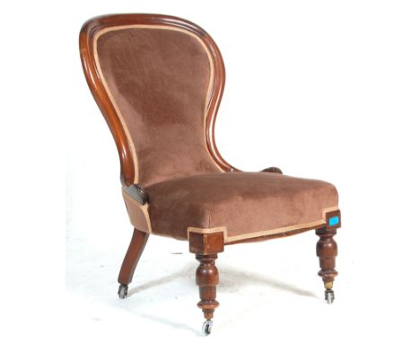 A 19th Century Victorian mahogany nursing chair / spoonback chair upholstered in chocolate brown fabric with a show wood fram