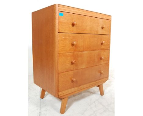 A vintage retro 1960's light / golden oak chest of drawers having a bank of four drawers having contrasting grain panels with