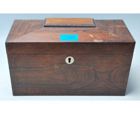 A 19th Century Victorian rosewood tea caddy of sarcophagus form with a mother of pearl escutcheon,&nbsp;the hinged lid enclos