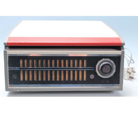 A vintage retro mid Century portable record player housing a Garrard turntable within set within in red and white leatherette