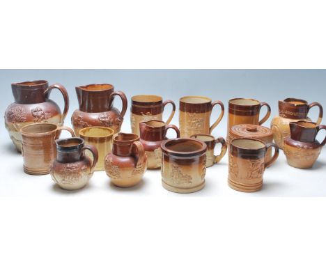A collection of 19th Century Victorian ceramic Harvest ware jugs / drinking vessels / flagons, some having raised decoration 