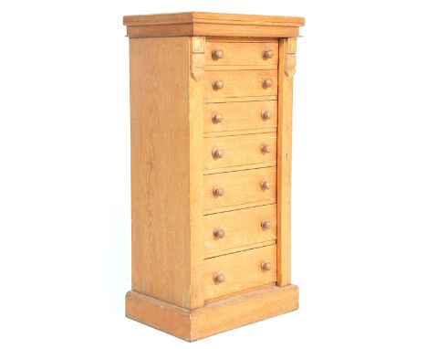 A 19th Century Victorian light oak Wellington chest of drawers. Raised on a plinth base with an upright bank of 7 drawers all