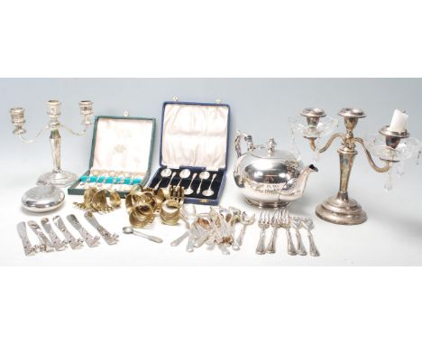 A collection of 20th Century silver plated wares to include a two branch armed candlesticks, two boxed sets of spoons (one be