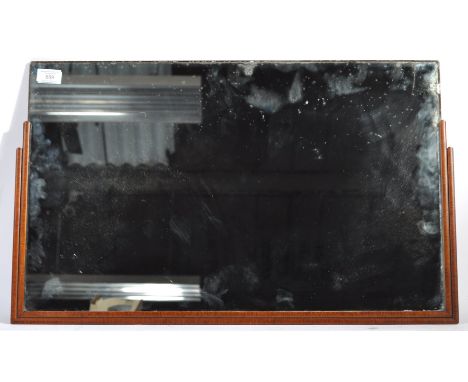 An original early 20th Century retro vintage Art Deco wall mirror having a stepped ebonised frame with mahogany veneer front.
