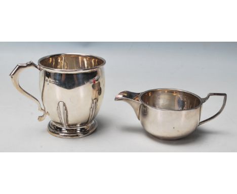 Pa pair of English silver hallmarked creamer jugs. One with circular pedestal base and Art Deco decoration to the body and sh