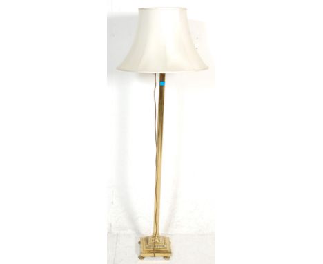 A good Victorian style brass floor standard lamp. The standard lamp with a square base raised on claw feet and Greek Corinthi