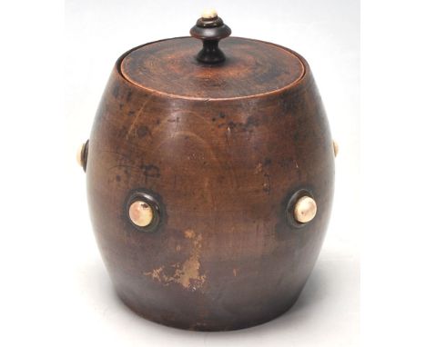 An early 19th Century tea caddy in a shape of a barrel with bone studs to the front and lead. Measures 10cm height.&nbsp;
