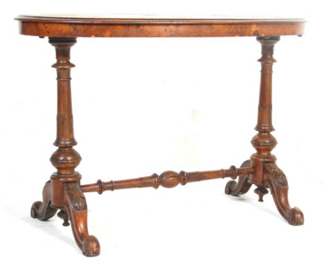 An antique 19th Century Victorian figured walnut writing table desk. The oval top with inlaid border and a floral centrepiece