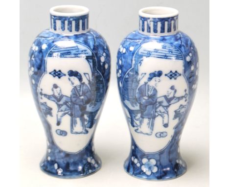 A true pair of 20th Century Chinese Kangxi vases of baluster form with decorated with plum blossoms and a mother and child. 4