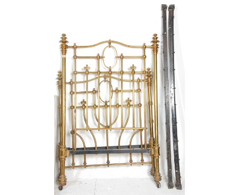 A good Victorian 19th century brass and cast iron single bed. The brass tubular head and footboard united by rails having fin