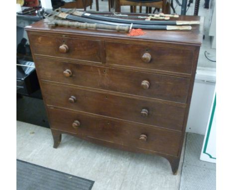 An early 19thC mahogany dressing chest with two short and three long drawers, each with a turned bun handle, raised on splaye