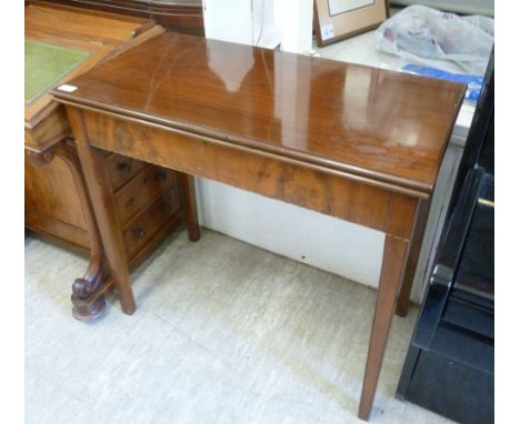 An early 19thC walnut tea table, the rectangular, foldover top with a cushion moulded edge, over a straight apron, raised on 