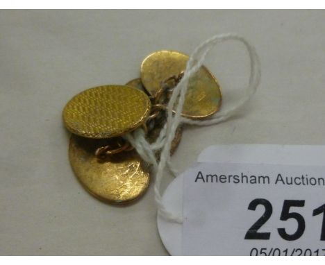 A pair of 9ct gold oval, engine turned tablet and chain cufflinks       11