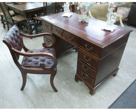 A modern mahogany finished nine drawer twin pedestal desk, raised on bracket feet  28''h  48''w; and a contemporary Regency s