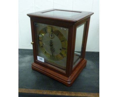 A modern J Kieninger, German made, mahogany cased four glass mantel clock with bevelled panels, on a bracket plinth; the expo