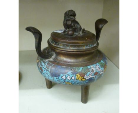 A 19thC Chinese twin handled brass censer with banded enamel ornament, the cover surmounted by a seated Dog of Fo, elevated o