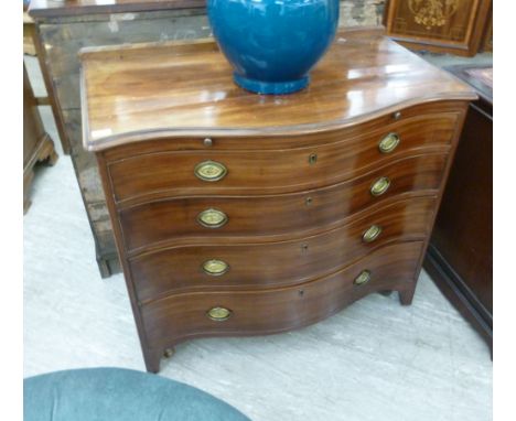 A 19thC mahogany serpentine front dressing chest, having a low galleried upstand with a brushing slide and four graduated dra