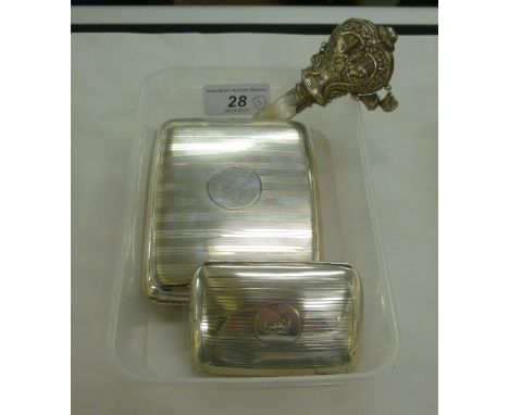 A silver folding cheroot case of curved form with engine turned ornament, on a button clasp  Chester 1918; a similar silver c