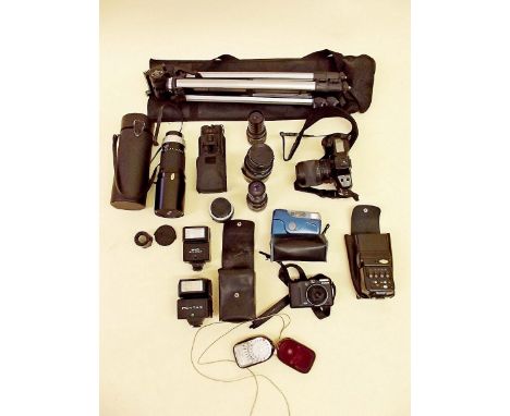A group of cameras and equipment including tripod, lenses, light meter etc