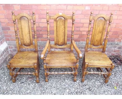 A set of eight Jacobean style panel back oak dining chairs comprising&nbsp; two carvers and six diners
