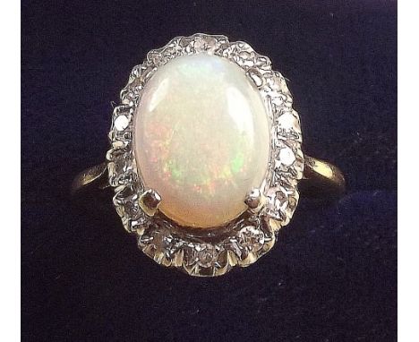 An 18 carat gold opal and diamond cluster ring, size N