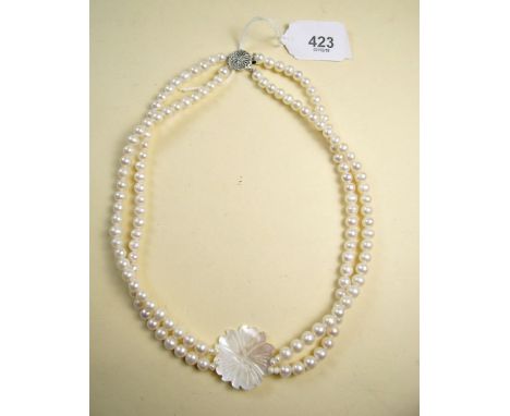 A double strand freshwater pearl necklace with mother of pearl flower panel
