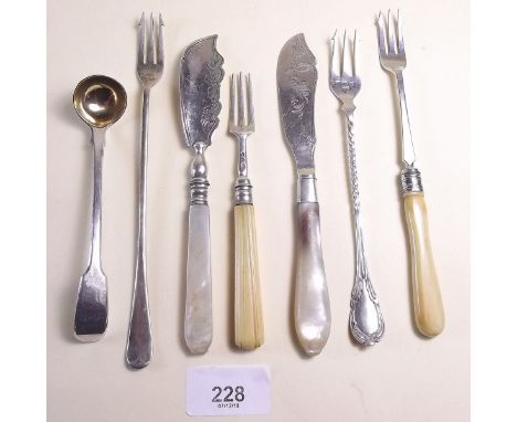 A small collection of silver cutlery items including three pickle forks and one other, two silver butter knives with mother o