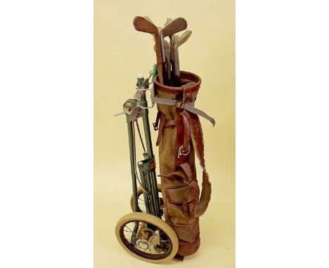 A set of antique golf clubs and caddy