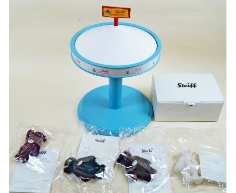 Four Steiff miniature bears with certificates and Steiff display carousel