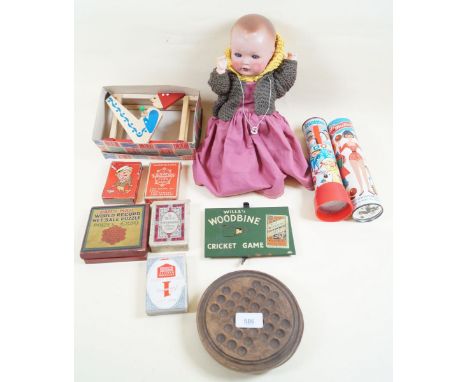 A box of various vintage games including a Will's Woodbine cricket game, and a German doll