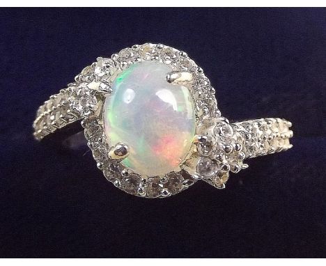 An Ethiopian opal set silver cross over ring, size Q