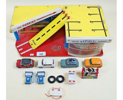 A toy car garage and showroom 'Mini International Garage' with service ramp, Dunlop tyre rack, fuel pumps and four various mi