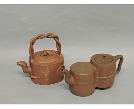 Two Chinese yixing teapots, one of square form with twisted bamboo handle and prunus finial, the other of double gourd form a