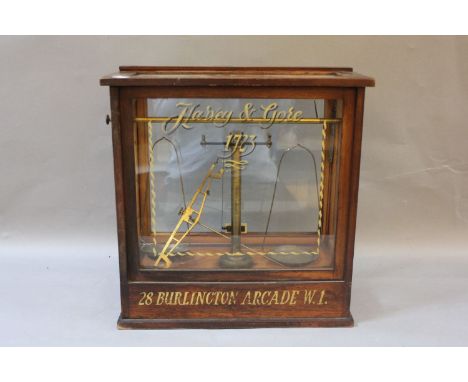 A cased brass scales case, painted 'Harvey & Gore, 28 Burlington Arcade', 43cm wide