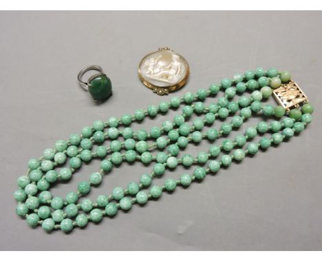 A three row Peking glass bead necklace, with gold clasp set with six jade beads to either side of the clasp, tested as approx