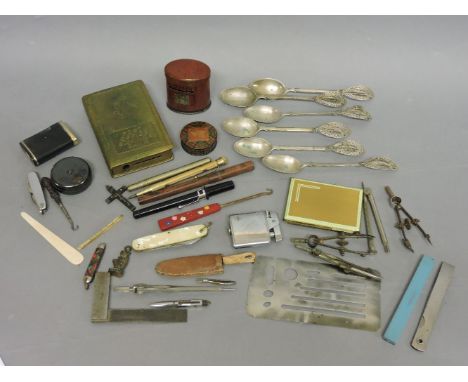 A collection of items, including lighters, pens, geometry instruments, set of six '800' teaspoons, two money boxes, etc