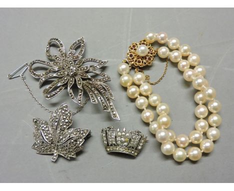 A two row cultured pearl bracelet, with 9ct gold pearl and garnet clasp, two silver brooches set with marcasite, and a silver