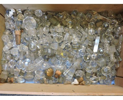 A large quantity of cut glass decanter and bottle stoppers